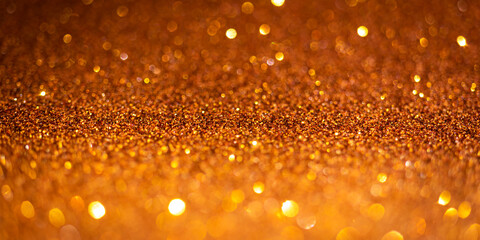 Orange glitter lights. Shiny sparkles, bokeh effects, glowing surface. Selective focus, christmas abstract banner, background