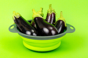 Clean washed eggplant for cooking in colander. Studio Photo.
