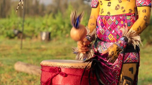 close up of prehispanic warrior hands drumming in open air ritual in Mexico