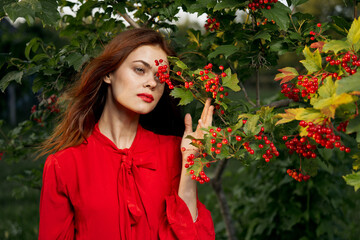 woman in red shirt near bush berries nature summer