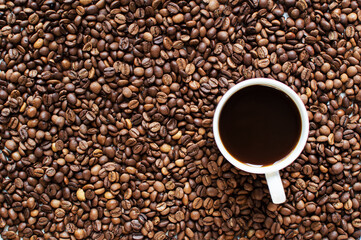 cup of aromatic coffee on a white background and scattered coffee grains. good morning . kind of sveru. flat lay. place for text. coffee time.

