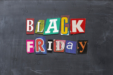 BLACK FRIDAY words on a blackboard with various colored letters from newspaper. November is sale time in stores and online.