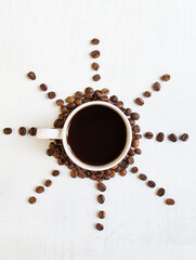 sun from coffee beans on a white background. Coffee time. kind of sveru. flat lay. space for inspirational text.

