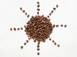 sun from coffee beans on a white background. Coffee time. kind of sveru. flat lay. space for inspirational text.


