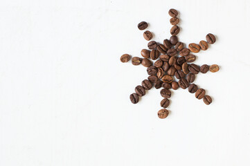 sun from coffee beans on a white background. Coffee time. kind of sveru. flat lay. space for inspirational text.

