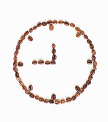 clock made from coffee beans on a white background. Coffee time. kind of sveru. flat lay. space for inspirational text.

