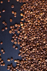 roasted aromatic coffee beans on a dark background. coffee background. flat lay with place for text. view from above.
