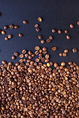 roasted aromatic coffee beans on a dark background. coffee background. flat lay with place for text. view from above.
