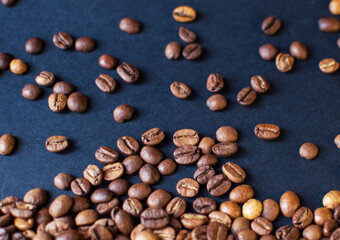 roasted aromatic coffee beans on a dark background. coffee background. flat lay with place for text. view from above.

