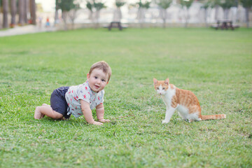 Baby child and ginger cat walking