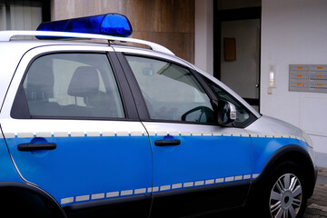 close-up of typical police vehicle in germany with blue flashers in city, used by the police to...