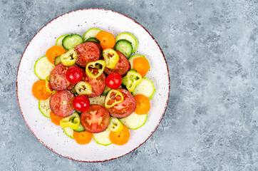 Vegetable slicing of seasonal vegetables on plate on gray-blue background. Studio Photo.