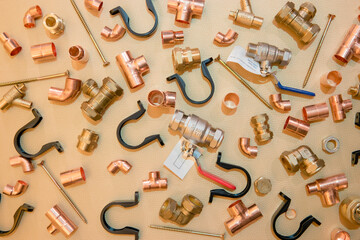 Range of plumbing supplies and components including pipes, valves, taps and more in flat lay