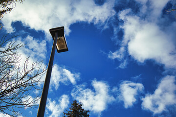 a street lamp with a blue and cloudy sky