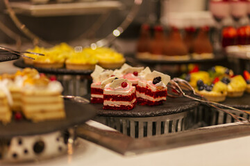 Assortment of confectionery, different types of desserts on the table. Sweet and tasty.