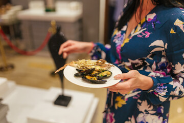 girl holding a plate of oysters