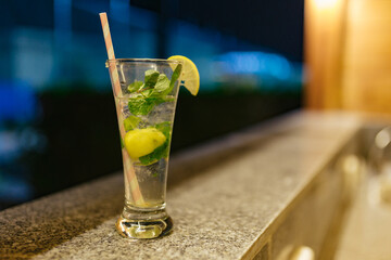 Glass with freshalcohol mohito on the table