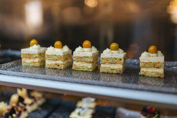 Assortment of confectionery, different types of cakes and desserts on the table.