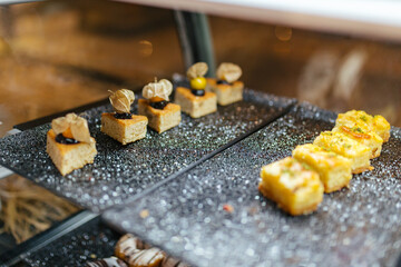 Assortment of confectionery, different types of cakes and desserts on the table. Sweet bakes.