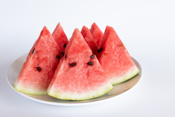 watermelon on plate isolated on white, side view