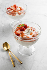 Healthy breakfast with cottage cheese, cream and strawberry and basil sauce. Homemade dessert, selective focus.