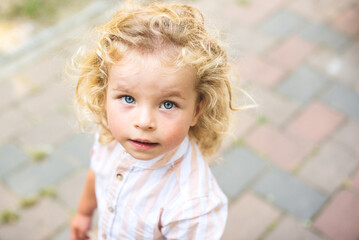 Handsome boy with blue eyes and curly blond hair