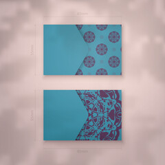 Presentable business card in turquoise color with mandala in purple pattern for your business.