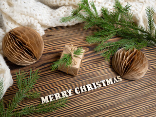 Christmas background. Handmade Christmas balls, a warm scarf, a fir tree and a gift. Zero waste