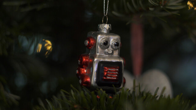 Decoration Toys on Christmas Tree. 4KShot. Nutcracker Soldier ,Vintage Robot on a Christmas Tree With Blurred Background. Beautiful Decorated Christmas Tree, the Fairy Lights. Rack Focus