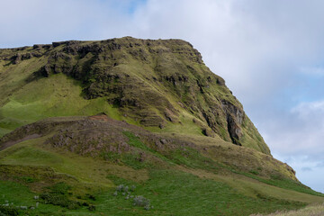 Cloudy landscape of grassy cliffs in Vik South Iceland