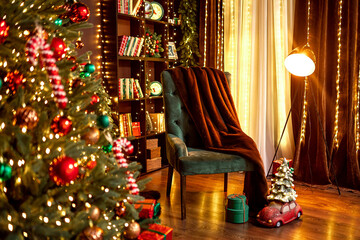Stylish room interior with cozy armchair and beautiful Christmas tree in evening. Cozy house 