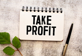 On a red background lies crumpled paper, a marker and a sheet of paper with the inscription - TAKE PROFIT
