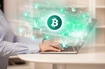 Young man watching stock market on laptop