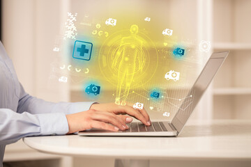 Doctor working on laptop with healthcare concept