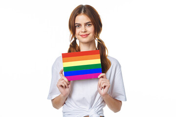 girl in white t-shirt lgbt flag transgender posing light background