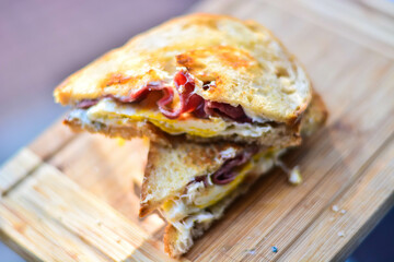 Egg sandwich on bread in natural light .