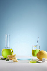 Lemon extract in test tube petri dish and lemon and sliced lemon , green leaf in a blue background blank space for product advertising , front view , photography experiment content 