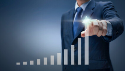 Businessman point hand on arrow graph with high rate of growth. Business man draw report chart up...