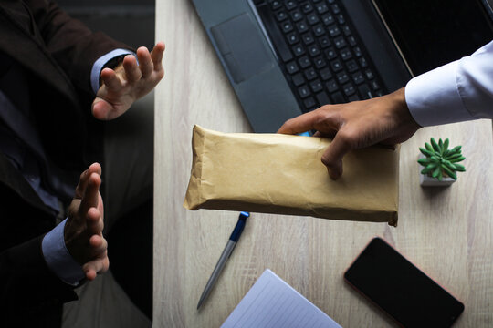 Businessman rejecting bribe money from his partner.