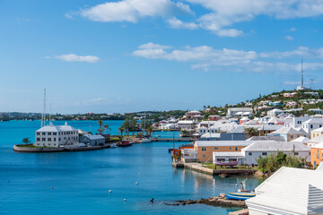 Fototapeta na wymiar Bermuda's Coastal Symphony: Where azure waters meet vibrant skies, lush landscapes cradle charming houses, creating a harmonious island masterpiece.