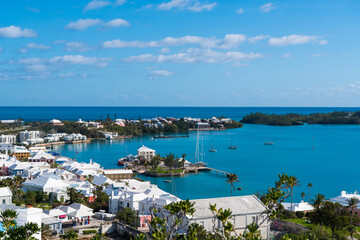 Bermuda's Coastal Symphony: Where azure waters meet vibrant skies, lush landscapes cradle charming houses, creating a harmonious island masterpiece.