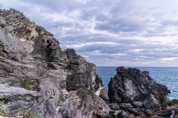 Fototapeta na wymiar Tobacco Bay's Coastal Charm: St. George's, Bermuda; where sturdy rocks frame azure waters, a picturesque blend of nature's beauty.