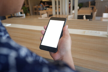 Mockup picture of business woman’s hands holding smart phone with white blank screen in modern place