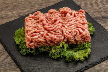 Raw pork minced meat over board
