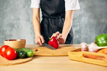 Obraz na płótnie Canvas Woman in black apron lunch at home vegetarian food