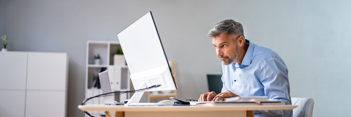 Man Sitting In Bad Posture Working On Computer - obrazy, fototapety, plakaty