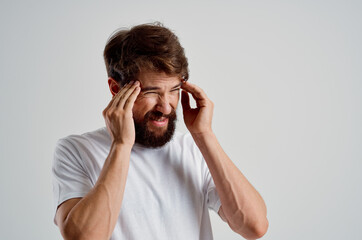 emotional man in a white t-shirt headache migraine problems isolated background