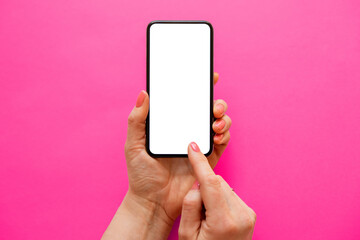 Person using mobile phone with empty white screen on bright pink background