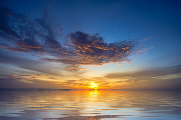 Naklejka na ściany i meble Sunset sky at the lake with clouds on the sky background.