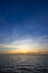 Sunset sky at the lake with clouds on the sky background.